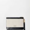 Túi Versace Riviere cầm tay màu be quai đen vải canvas phối da MTV017 2026 Túi Versace Riviere cầm tay màu be quai đen vải canvas phối da MTV017 2026