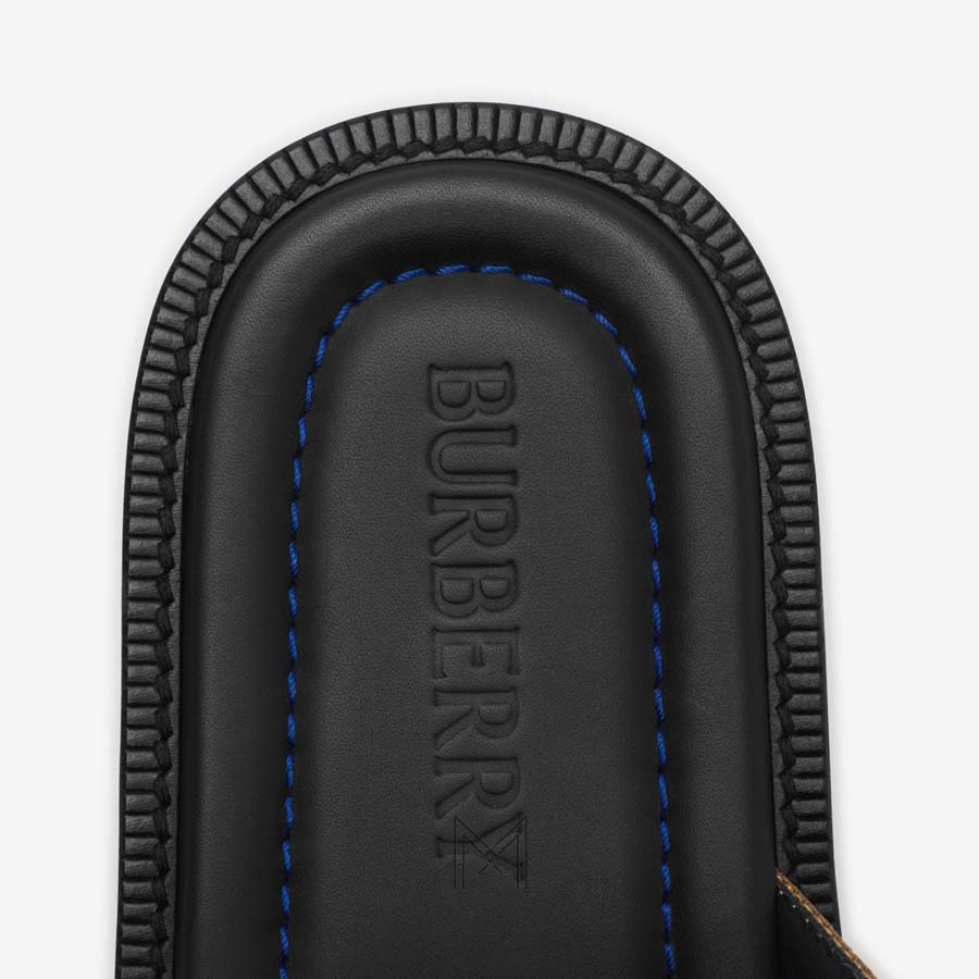 Dép Burberry quai chéo chính hãng màu đen họa tiết MHDB017 2026 Dép Burberry quai chéo chính hãng màu đen họa tiết MHDB017 2026
